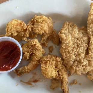 4 fried shrimp and a fried fish filet. Piping hot. My half of the dinner.