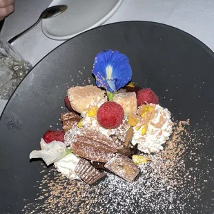 a dessert on a black plate