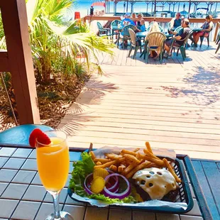 Swiss Burger with Fries and a Mimosa by the Lake
