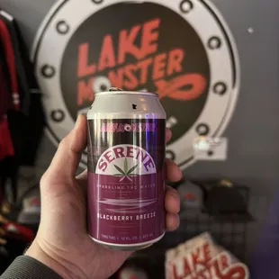 a hand holding a can