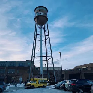 a water tower in a parking lot
