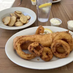 Fish log, onion rings and fried potatoes.