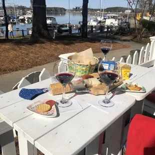 Nice assortment of meats and cheeses with a couple bottles of wine--lakeside!
