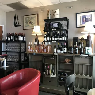 a wine shop with a red chair