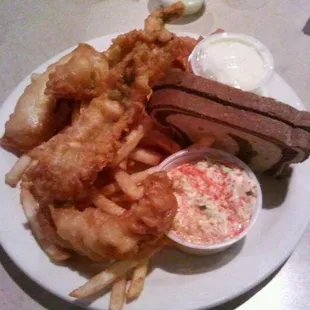 a plate of food including a steak, fries, and coleslaw