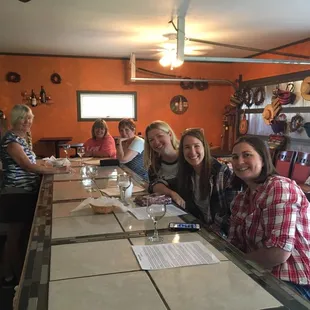 a group of people sitting at a bar