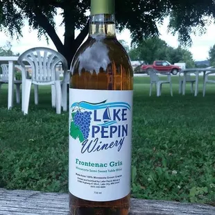 a bottle of wine on a picnic table