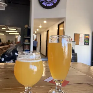 two glasses of beer on a table