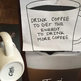 a cup of coffee and a sign that reads drink coffee to get the energy to drink more coffee