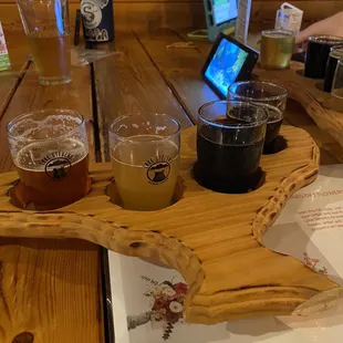 a table with beer glasses and a tablet