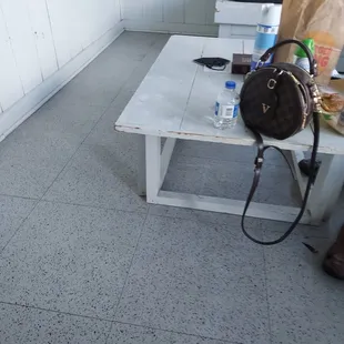 a white bench with a bag on it