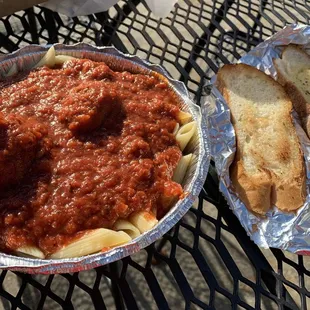 Penne with meatballs and garlic bread.