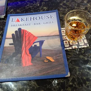 a glass of beer and a menu