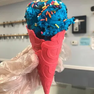 a cone of ice cream with sprinkles