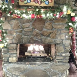 a fireplace decorated for christmas