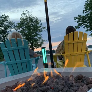 fire pit with chairs and umbrellas