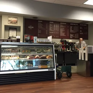 a man standing in front of a deli counter