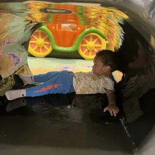 My son under the soft play bridge