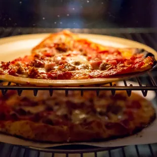 two pizzas in an oven