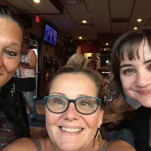 three women smiling for the camera