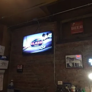 a television mounted on a brick wall