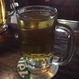 a glass of beer on a coaster