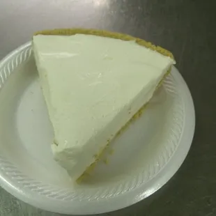 a slice of cheesecake on a paper plate