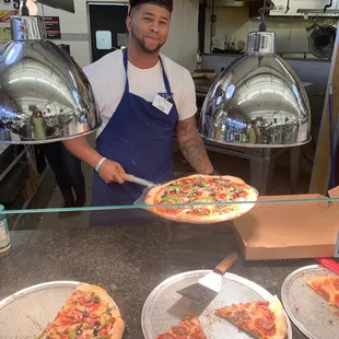 Samuel delivering a local Pizza! Nothing like grocery store fresh vegetables on you fresh pizza.