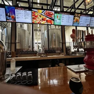 The view of the bar with menus and the brewery in the background.