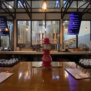 a bar with a red vase