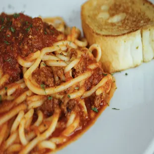 spaghetti and bread on a plate