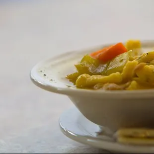 a bowl of soup and crackers
