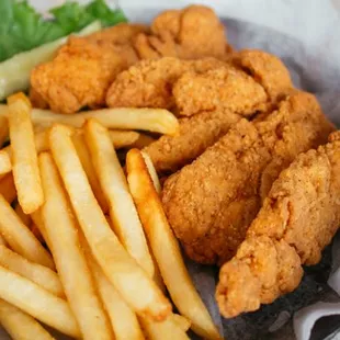 a basket of fried chicken and french fries
