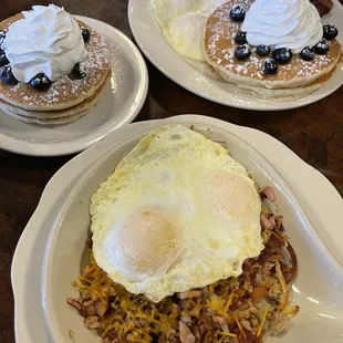 Meat lovers skillet with over easy eggs &amp; blueberry pancakes, and the two by four (2 bacon, 2 sausage patties, 2 eggs, 2 pancakes)