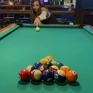 a woman playing pool