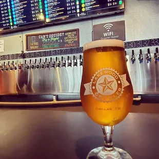 a glass of beer on a bar