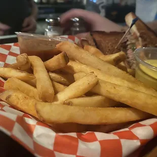 a basket of fries and a sandwich