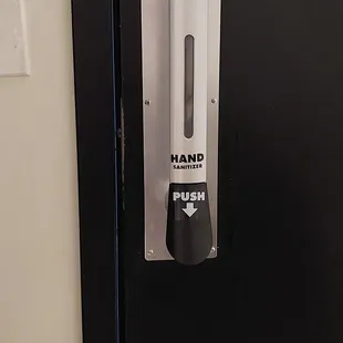 Hand sanitizer dispenser built into the bathroom door handle!