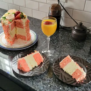 a slice of cake and a glass of orange juice