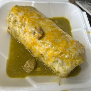 a burrito in a styrofoam container