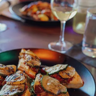 a plate of food and a glass of wine