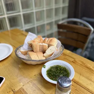 a plate of bread and a bowl of pesto