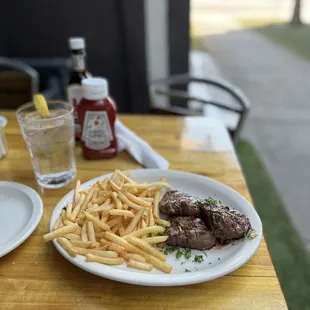 a plate of steak and french fries