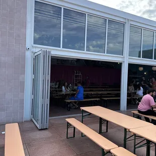 a group of people sitting at picnic tables