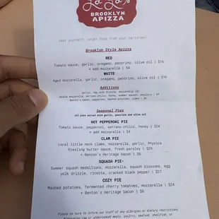 a hand holding a menu