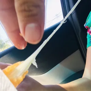 a person holding a piece of food