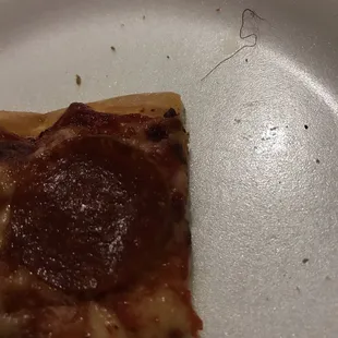 Found a red string on my pizza.