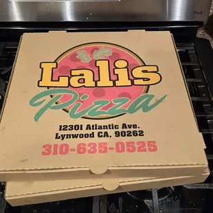 a pizza box on top of a stove