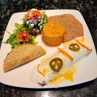 The Americano dinner - chicken enchilada, brisket taco, sope oaxaca, Mexican rice, and refried beans