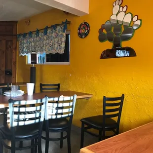 a dining room with yellow walls